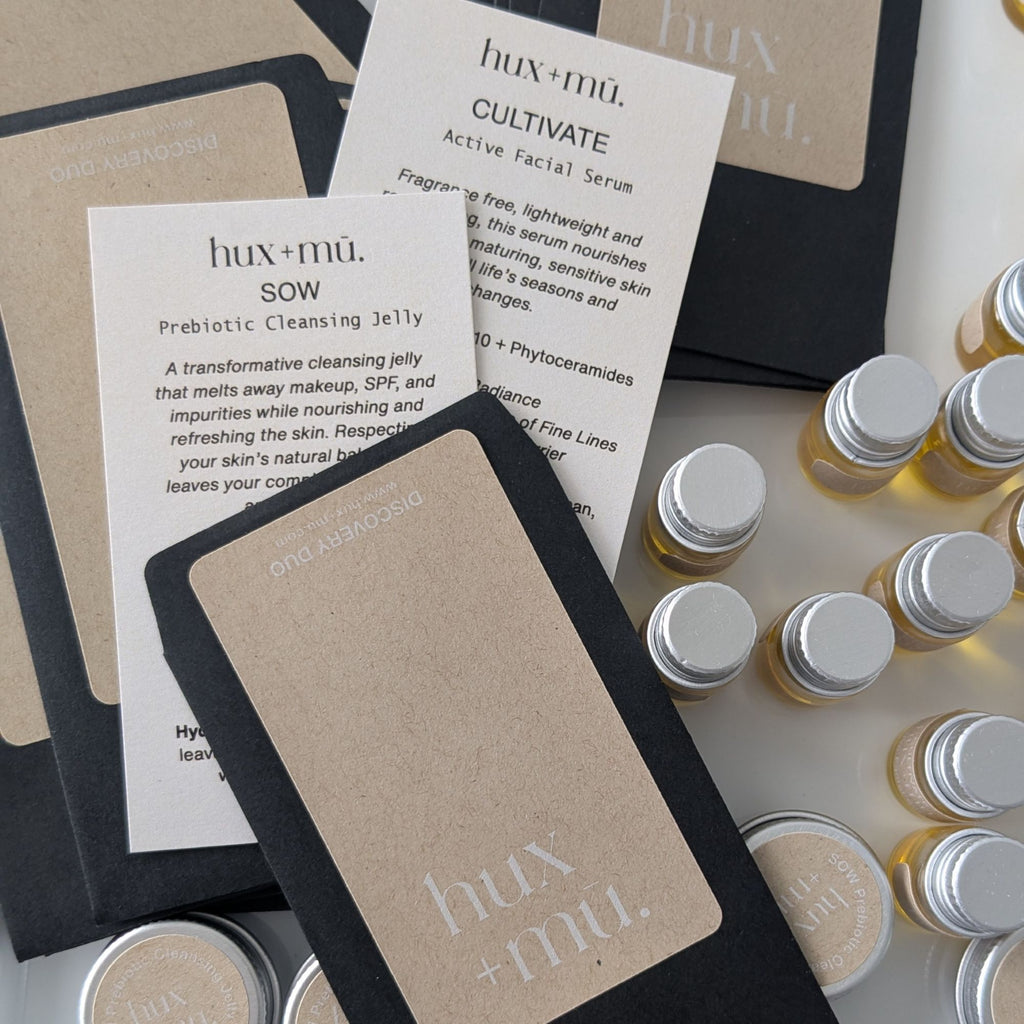 hux+mu skincare products including bottles and cards on a white background