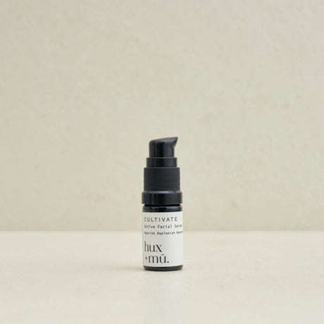 5 ml bottle of hux and mu cultivate active facial serum in neutral setting