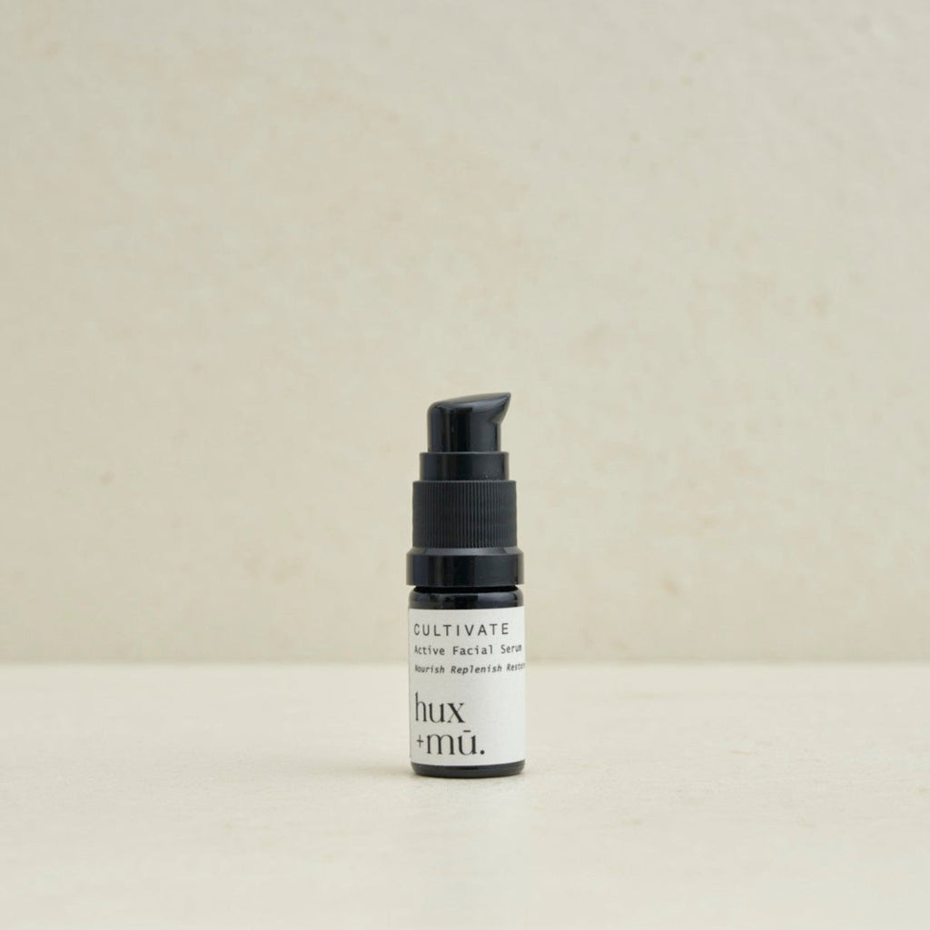 5 ml bottle of hux and mu cultivate active facial serum in neutral setting