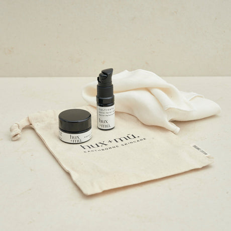 hux and mu mini mu signature ritual facial cleansing kit in neutral setting with drawstring bag and muslin face cloth