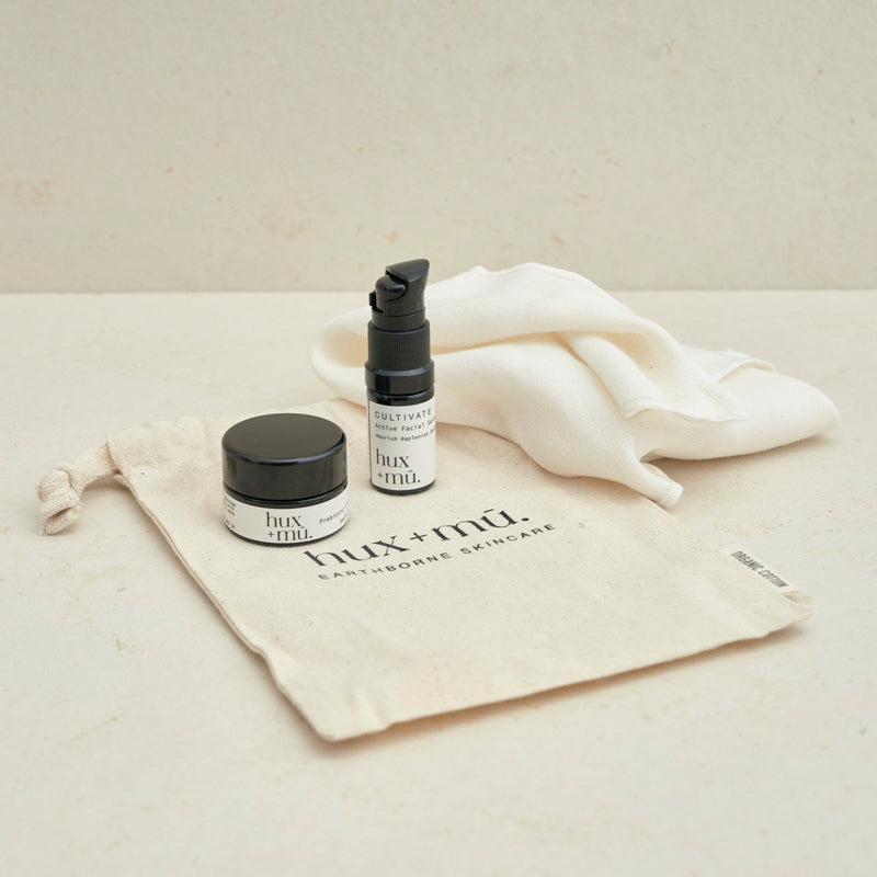 hux and mu mini mu signature ritual facial cleansing kit in neutral setting with drawstring bag and muslin face cloth