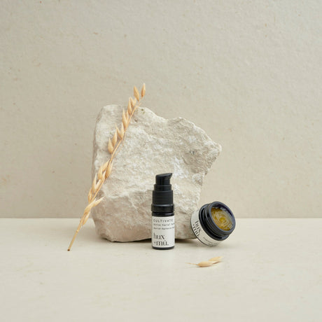 hux and mu mini mu signature ritual facial cleansing kit in neutral setting with stone and dried foliage